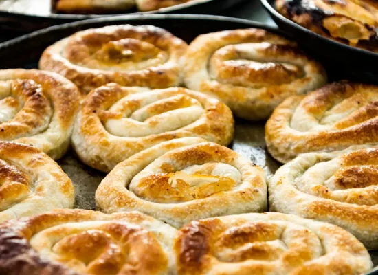 Traditional Bosnian burek baked in trays, representing authentic Bosnian cuisine