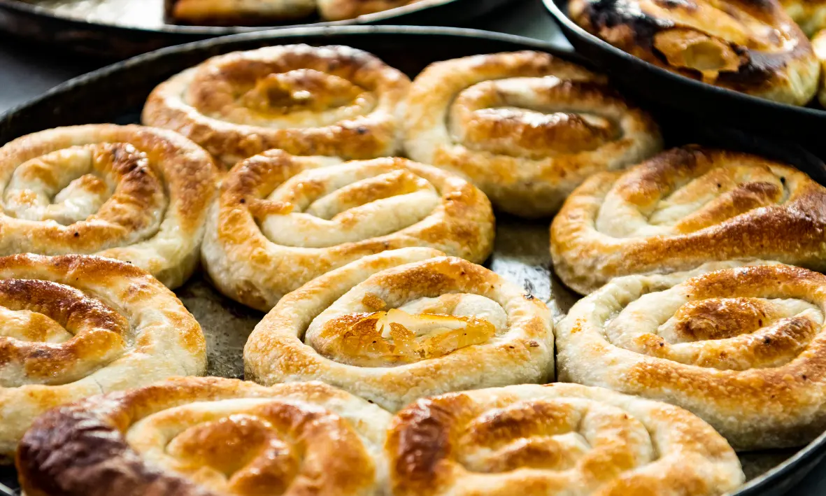 Traditional Bosnian burek baked in trays, representing authentic Bosnian cuisine