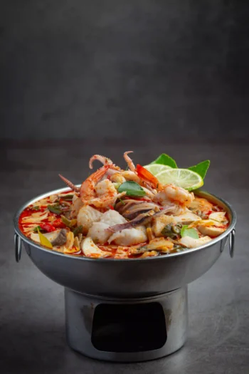 شوربة Tom Yum التايلندية الحارة بالمأكولات البحرية مع الليمون والأعشاب التايلندية التقليدية